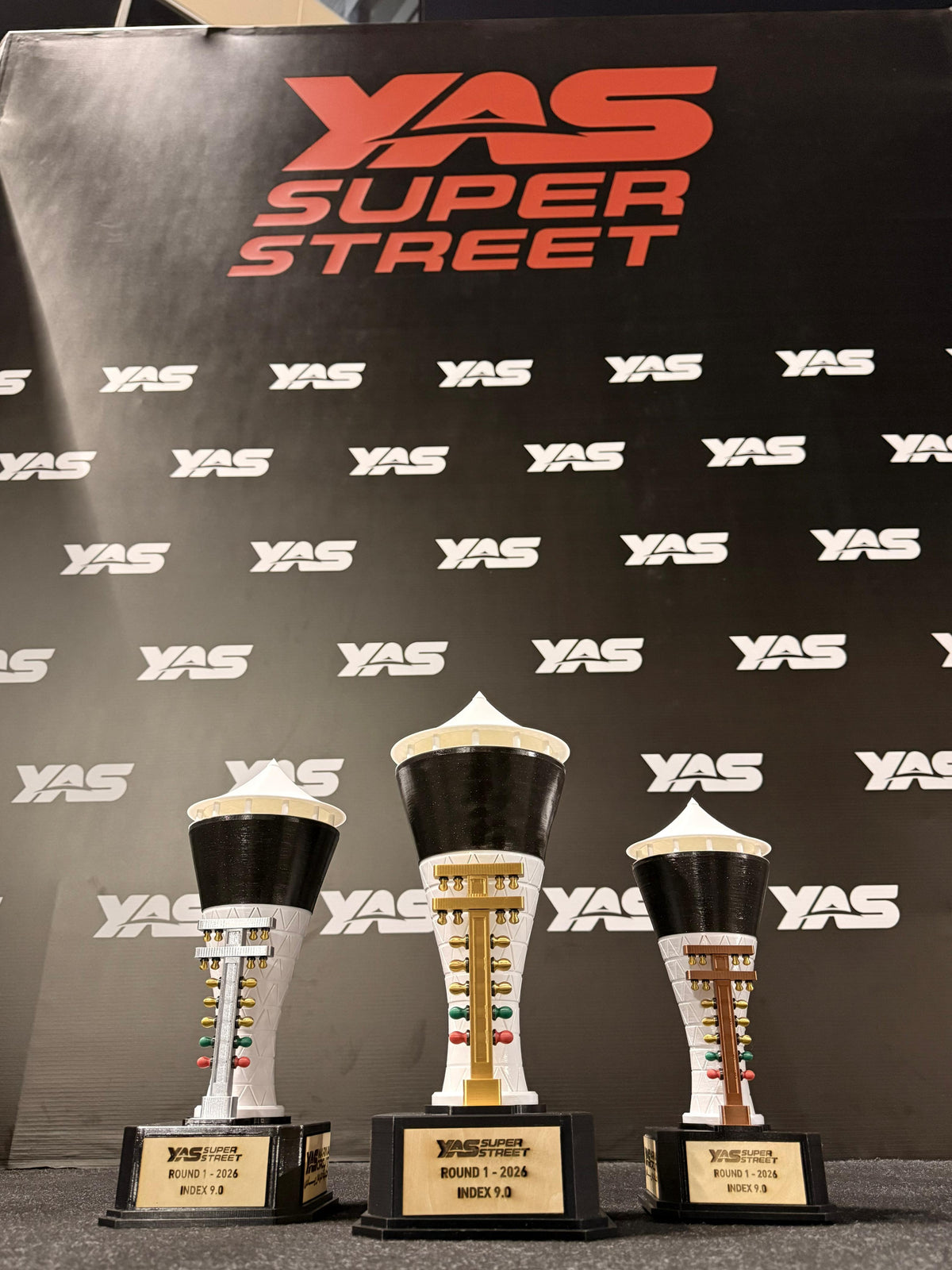 YAS Super Street trophies with gold, silver, and bronze racing tree ornaments